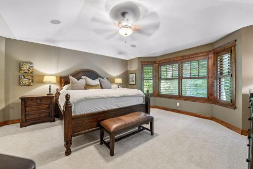 This large primary bedroom feels open and inviting with its beautiful vaulted ceilings.