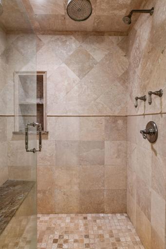 The primary bathroom includes a comfortable walk-in shower, adding ease and everyday luxury.