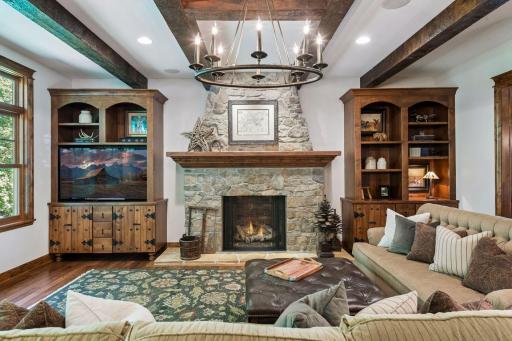 The large stone gas fireplace serves as the focal point of the living room.