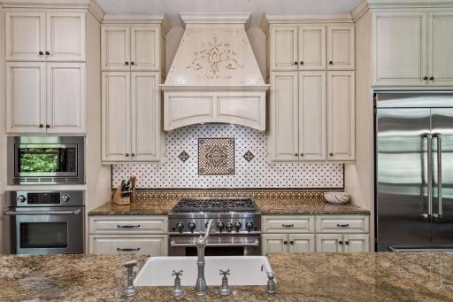 The kitchen is defined by beautiful custom cabinetry and a unique, thoughtfully crafted design.