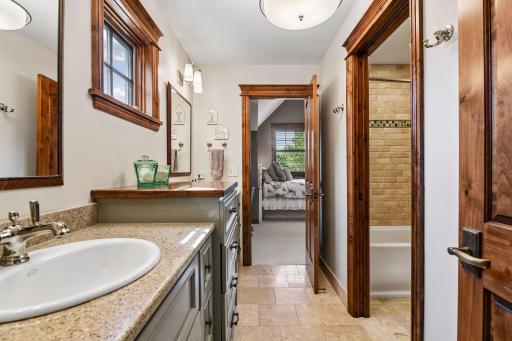 The Jack-and-Jill bathroom includes a separate tub and stool room for added privacy and convenience.