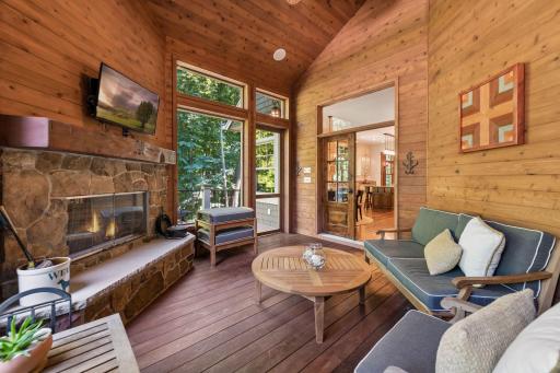 The inviting 3-season porch features a generous seating area and a convenient door to the deck, creating an easy indoor-outdoor connection.