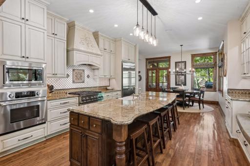The kitchen features stainless steel appliances along with a cabinet-flush refrigerator, built-in microwave, and wall oven for easy everyday living.