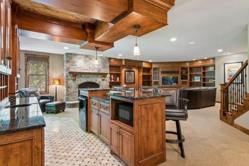 The bar area includes a microwave and refrigerator, offering convenient amenities for entertaining.