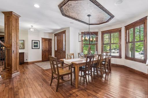 The dining room is open to the foyer and offers beautiful views of the front yard.