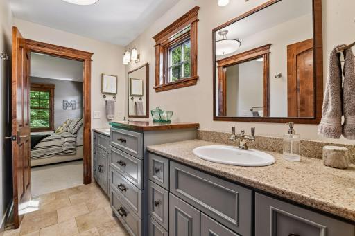 Shared between bedrooms 2 and 3, the Jack-and-Jill bathroom includes a spacious vanity with two sinks and two mirrors for easy morning routines.