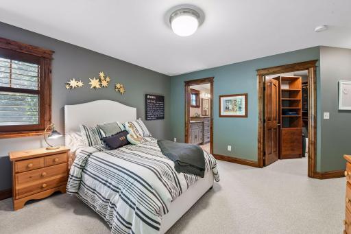 This upper-level second bedroom includes a private walk-in closet and convenient access to the shared Jack-and-Jill bathroom.
