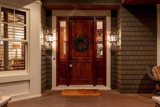 A warm and inviting front door anchors the spacious porch, creating a charming first impression.