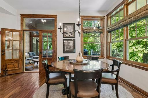 The dining area opens up into the 3-season screened porch, extending the home’s indoor-outdoor living.