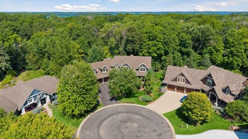Aerial view of the home situated on a quiet cul-de-sac, backing up to a beautiful expanse of mature trees.