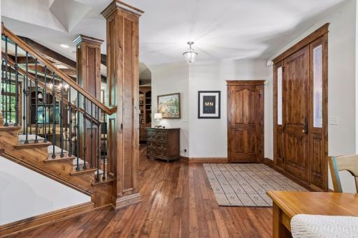 Large entry foyer welcomes you into the open-concept living and dining areas, with a staircase leading to the upper level.