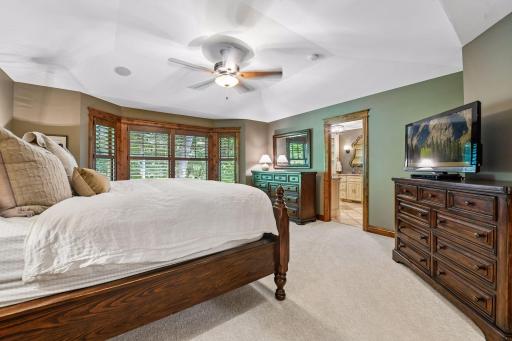 The spacious primary suite connects to a large ensuite bathroom, creating a comfortable and relaxing retreat.