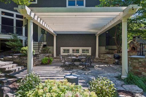 The patio and pergola look stunning in the daylight, creating a bright and inviting outdoor space.