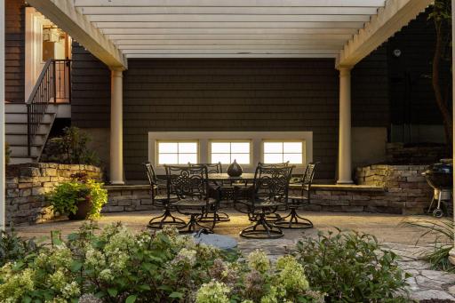 The backyard features a peaceful, private patio with a charming pergola—an ideal spot to unwind.