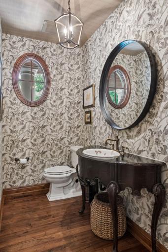 The main-floor powder room is tastefully decorated, offering a refined touch for guests.