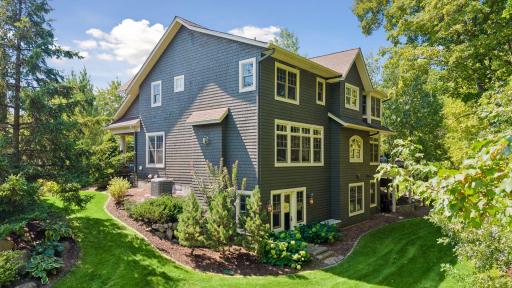 The entire yard is professionally landscaped, creating a polished and inviting outdoor setting.