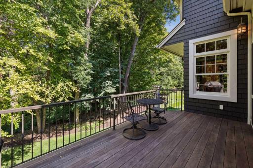 Enjoy a spacious main-floor deck overlooking the peaceful, tree-lined backyard.