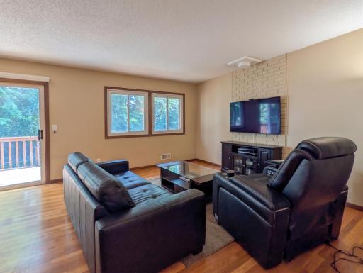 Upper light-filled living room with sliding door to the deck (virtually staged)