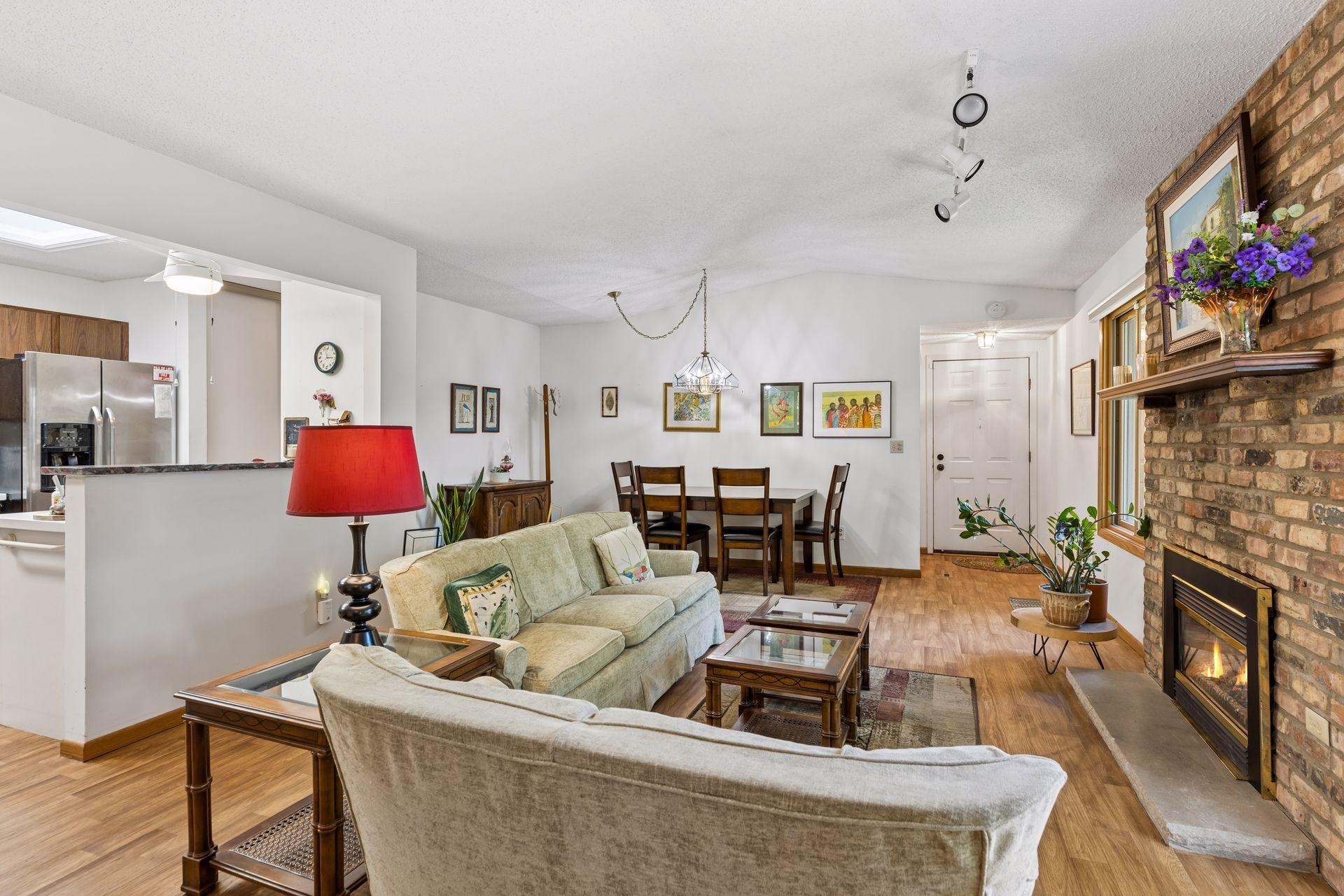 Large living room with newer flooring open to Kitchen