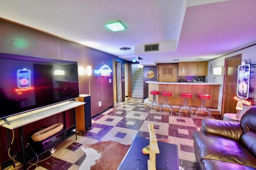 Step back in time to this fun retro bar, game room, family room which is perfect for entertaining or watching the big game!