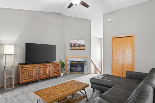 Vaulted ceilings bring in natural light, making this spacious living area feel bright and airy.