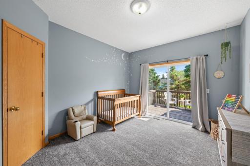 Bedroom 2 complete with a walk-in closet, french doors, and access to the deck.