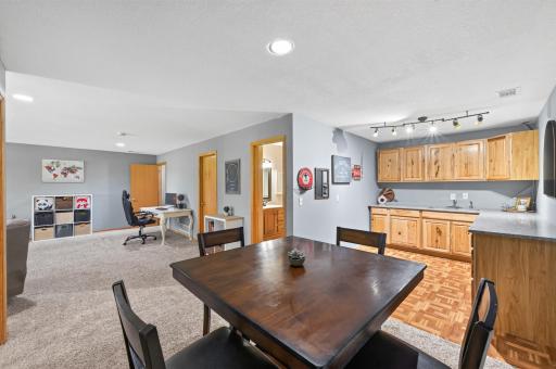 Complete with a wet bar featuring tons of storage and counter space, maximizing the square footage.