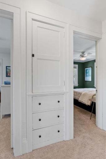 Linen closet and storage drawers in hallway