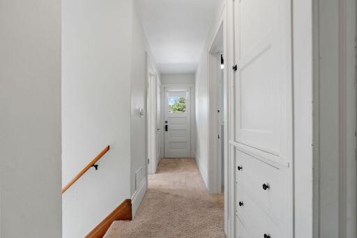 Upstairs hallway with extra storage closet and drawers.