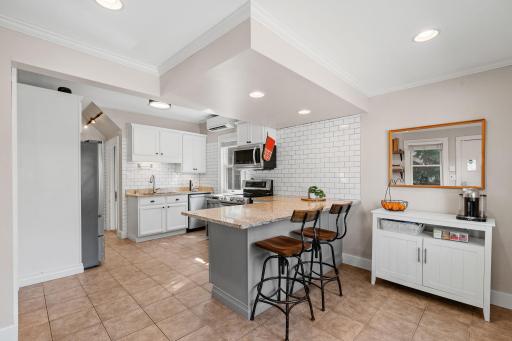 Remodeled kitchen has granite c-tops, breakfast bar, and prep space.