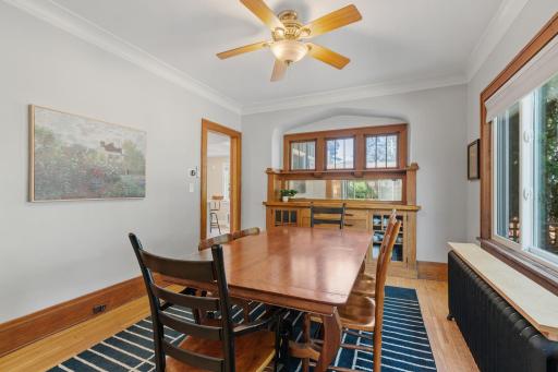 Formal dining room with a classic mirrored buffet and windows