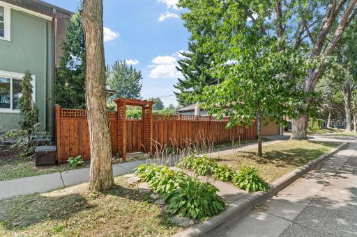 Privacy fence with gate to the back yard and patio.