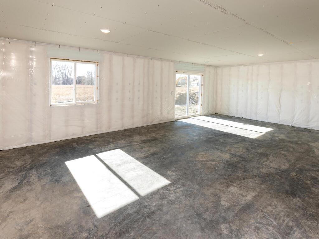 Unfinished Lower Level. Photo taken of another home with similar plan and finishes. Photos and renderings may not depict actual plan, materials, & finishes may vary. All measurements are approximate.
