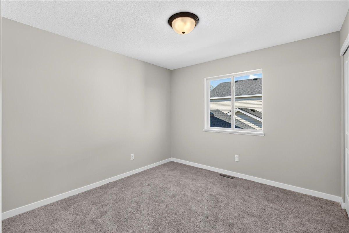 Bedroom 3. Photo taken of another home with similar plan and finishes.