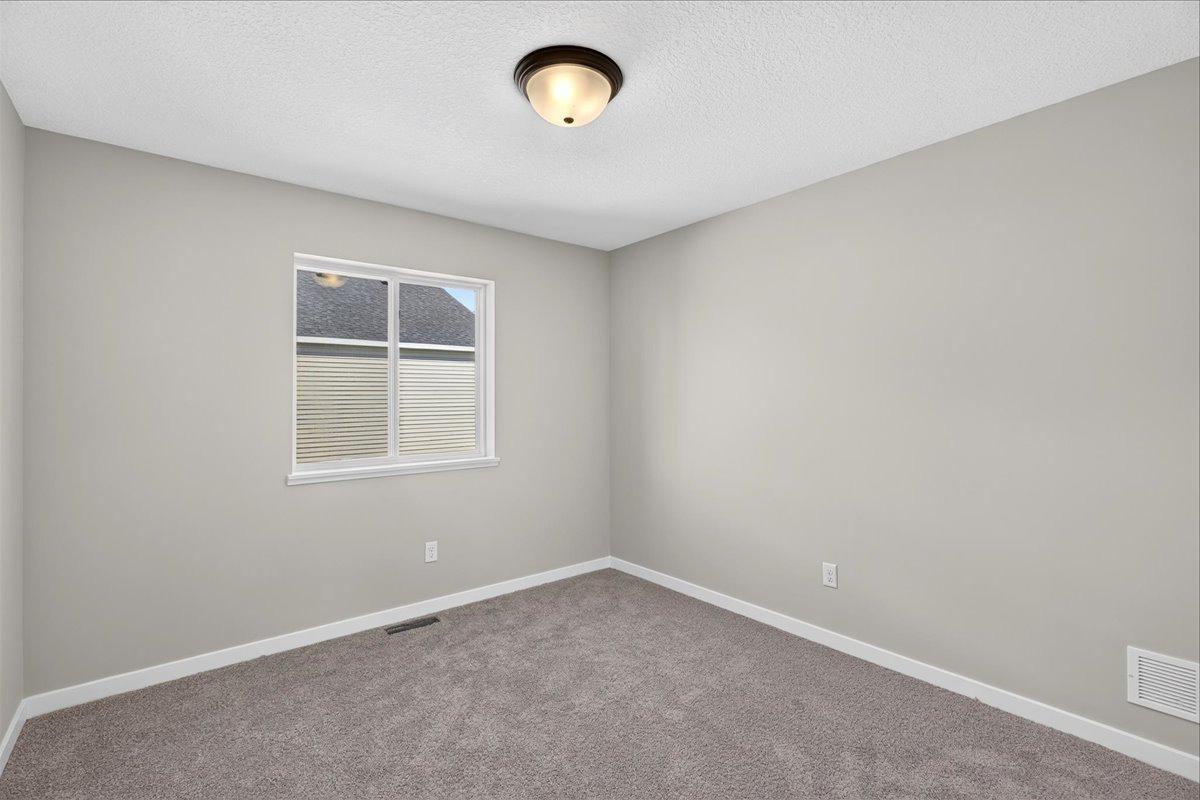Bedroom 2. Photo taken of another home with similar plan and finishes.