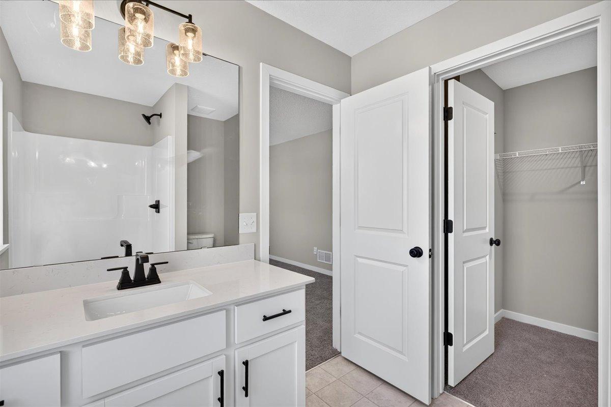Private Primary Bath. Photo taken of another home with similar plan and finishes.