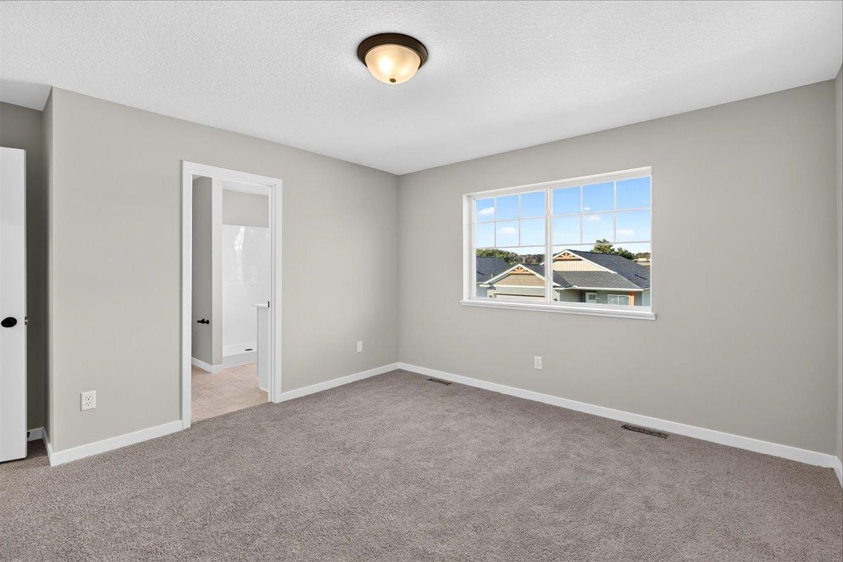 Primary Suite. Photo taken of another home with similar plan and finishes.