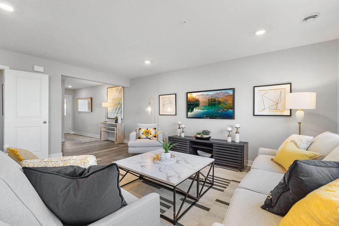 Spacious main level is light & bright with lots of windows and 9-foot knockdown ceilings. Photo is of model home. Colors and options may vary. Ask Sales Agent for details.