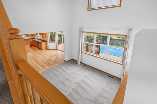 2 story Living room with ceiling fan