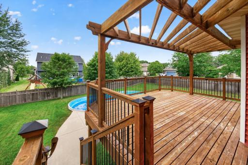 Deck with Steps to grade met with concrete walkway to pool