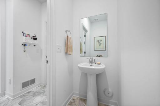 Convenient main-level powder room with clean, bright finishes for guests