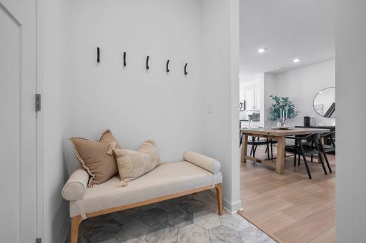 A nice little spot just off the garage entry makes the perfect drop zone, with space for a bench, hanging coats, and keeping everyday essentials organized
