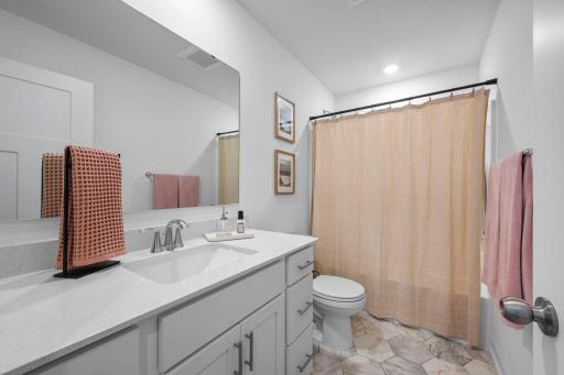 The additional full bath continues the home’s fresh, modern feel with a spacious vanity and great storage