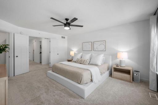 Another look at the generous primary suite through french doors, offering plenty of space for a king-size bed and additional furniture without feeling crowded