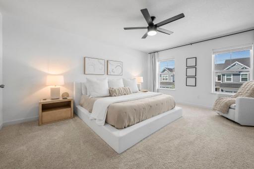 The spacious primary bedroom feels bright and peaceful, with soft neutral finishes, great natural light, and plenty of room to unwind
