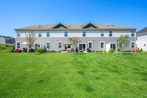 A wide-open stretch of green space behind the home gives the neighborhood a spacious, open feel with plenty of room to enjoy the outdoors