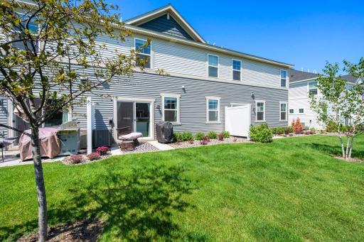 Outside enjoy a sunny backyard with plenty of green space and a patio just off the home separated by privacy walls