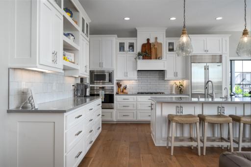 Sub-Zero refrigerator, Wolf range, and custom tile backsplash.