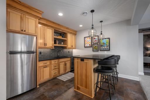 Hickory cabinetry, shelving, and custom hardware make this wet bar warm and inviting.