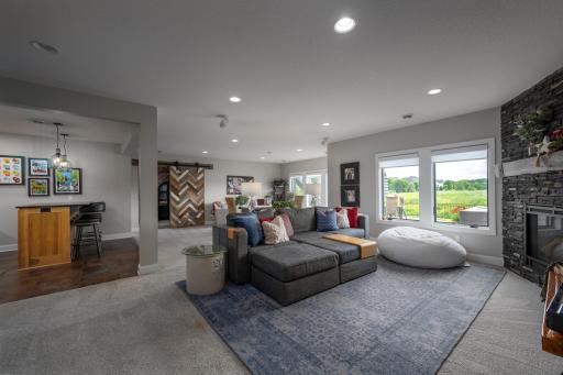 Large 26x30 family room with corner custom fireplace and game area.